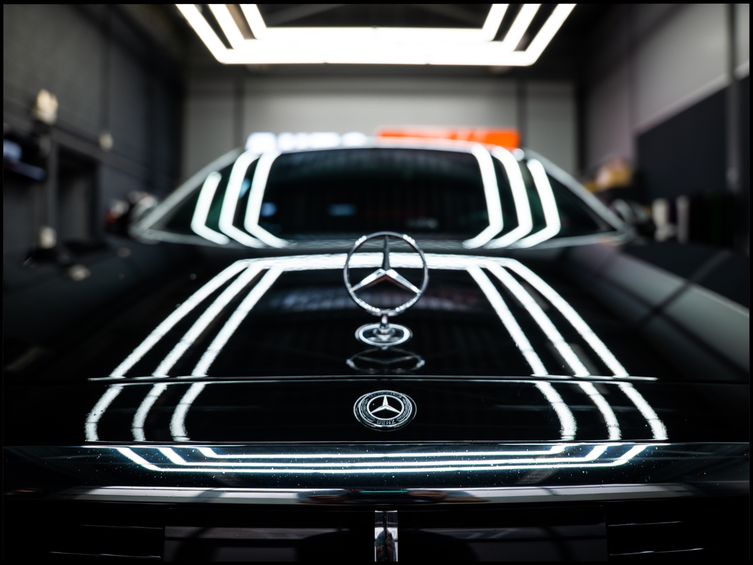 Mercedes hood ornament framed by studio light