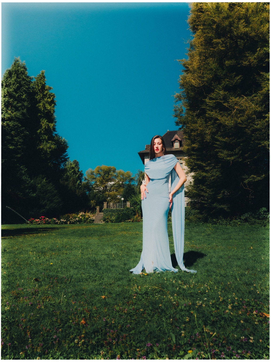 Editorial fashion portrait in a blue dress
