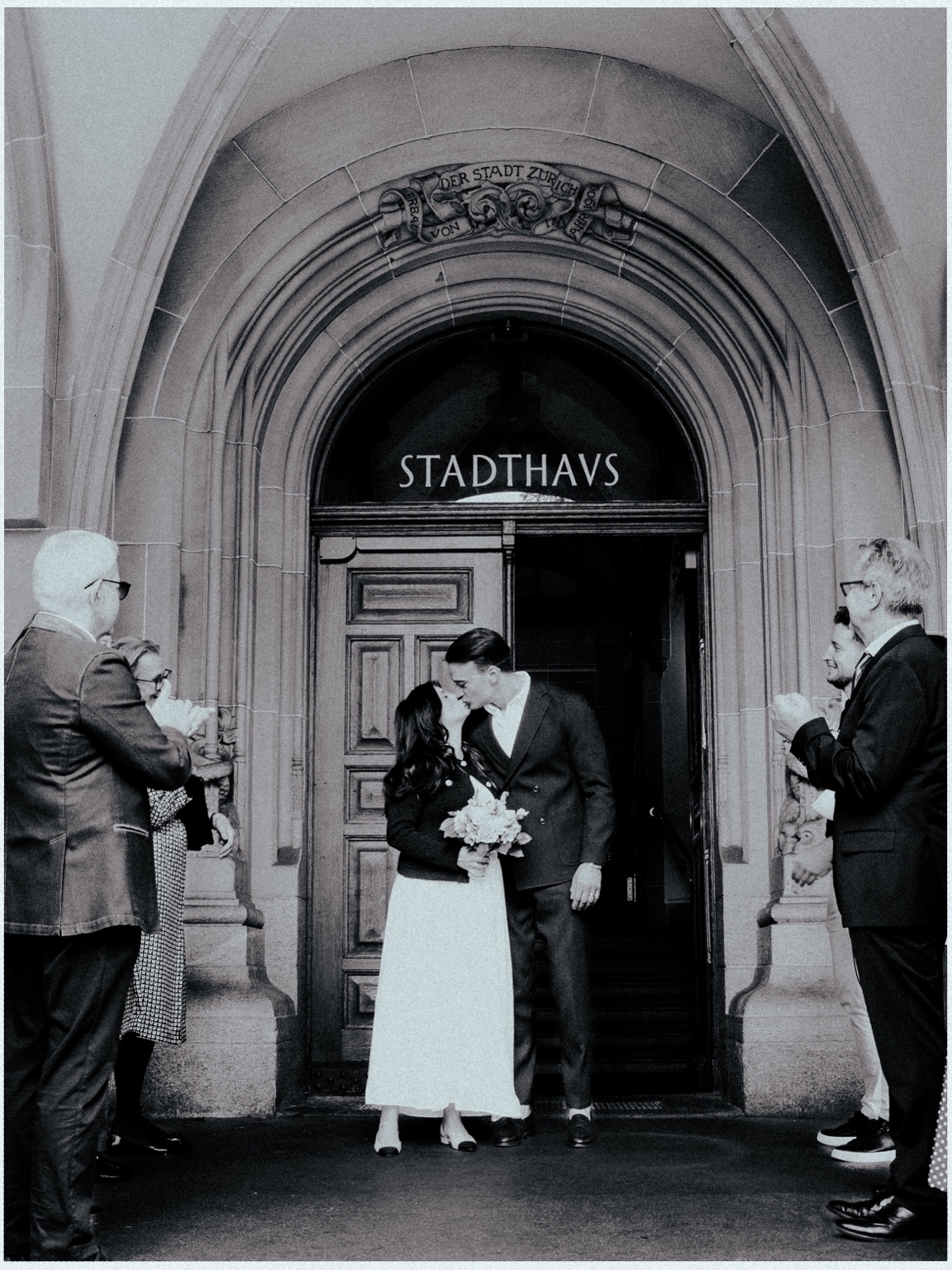 Newlyweds kissing outside Zurich city hall
